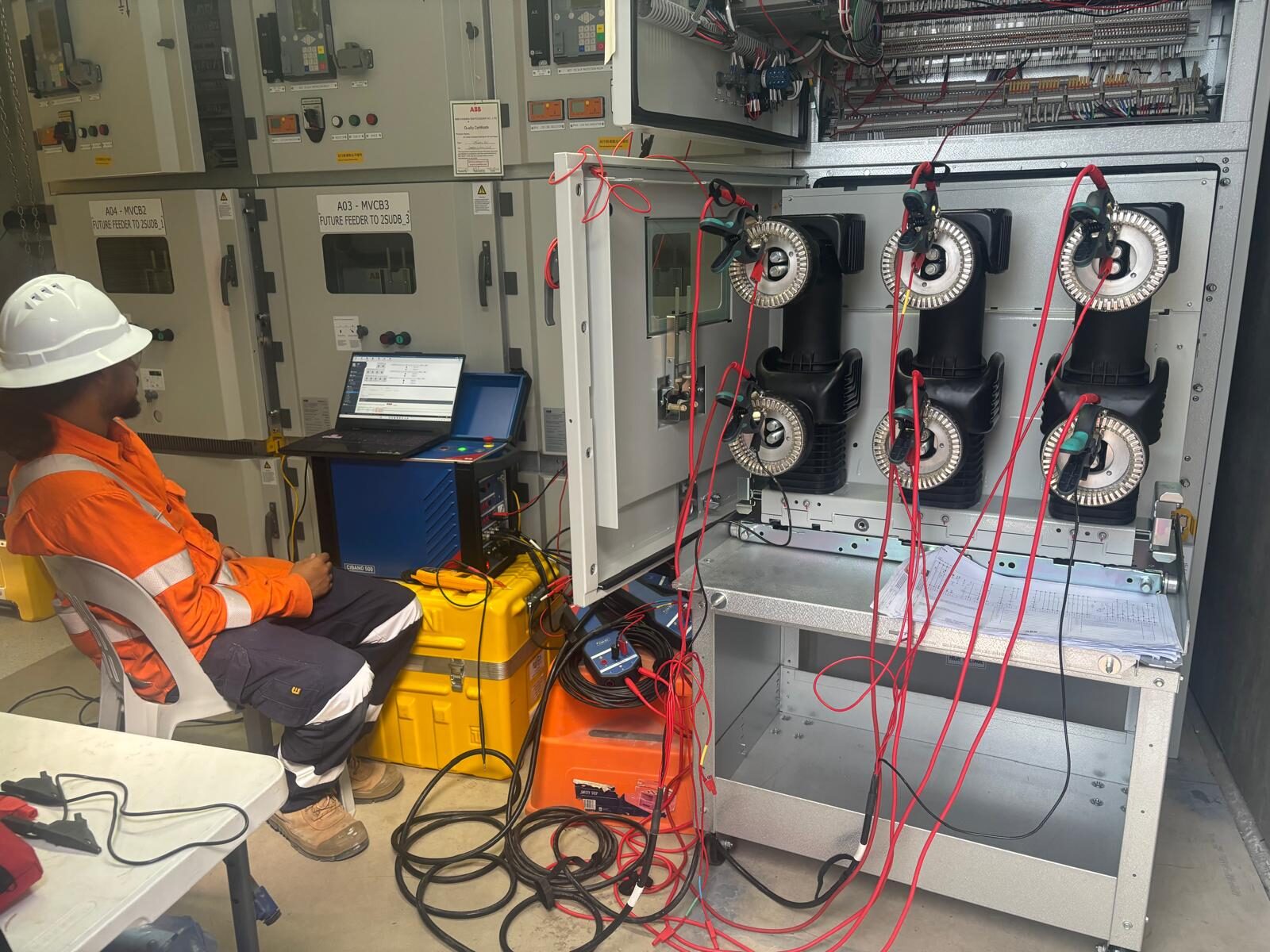 A Nebula technician running injection tests on switchgear with a test set