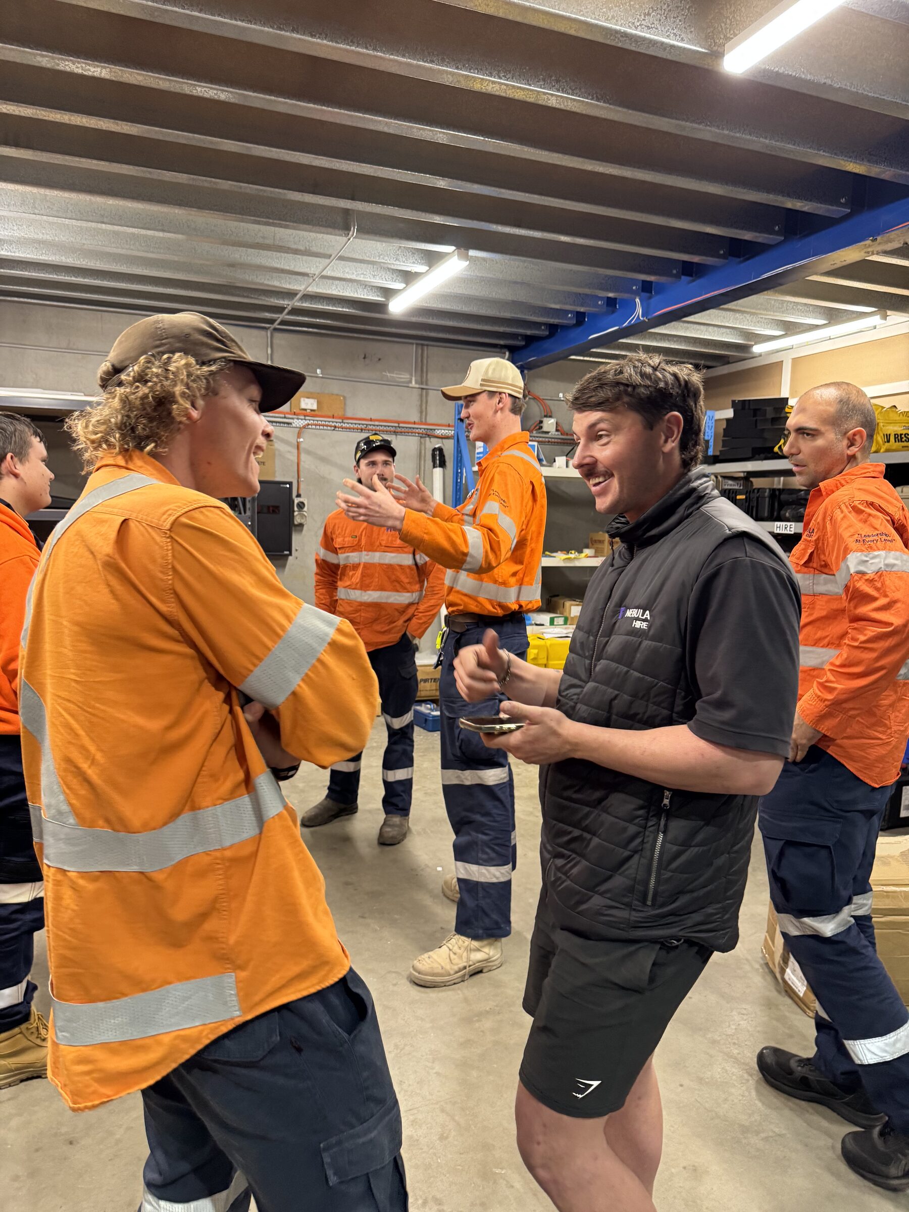 Apprentices talking with a trainer between sessions