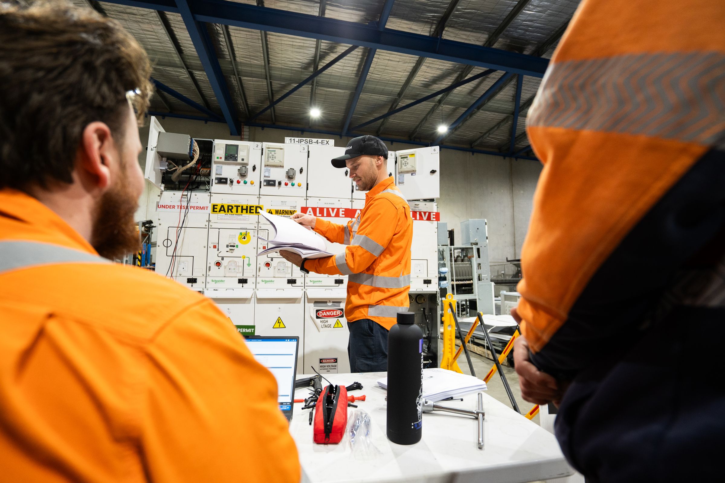 A Nebula technician reviewing test notes at the training switchboard